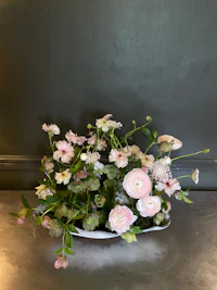 a vase of flowers sitting on a wall