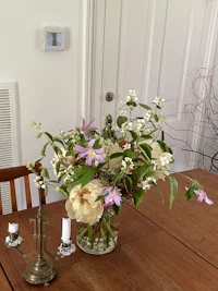a vase of flowers on a wooden table